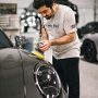 "Technician performing professional detailing on a car, showcasing PRO LINE’s premium shine and finish"